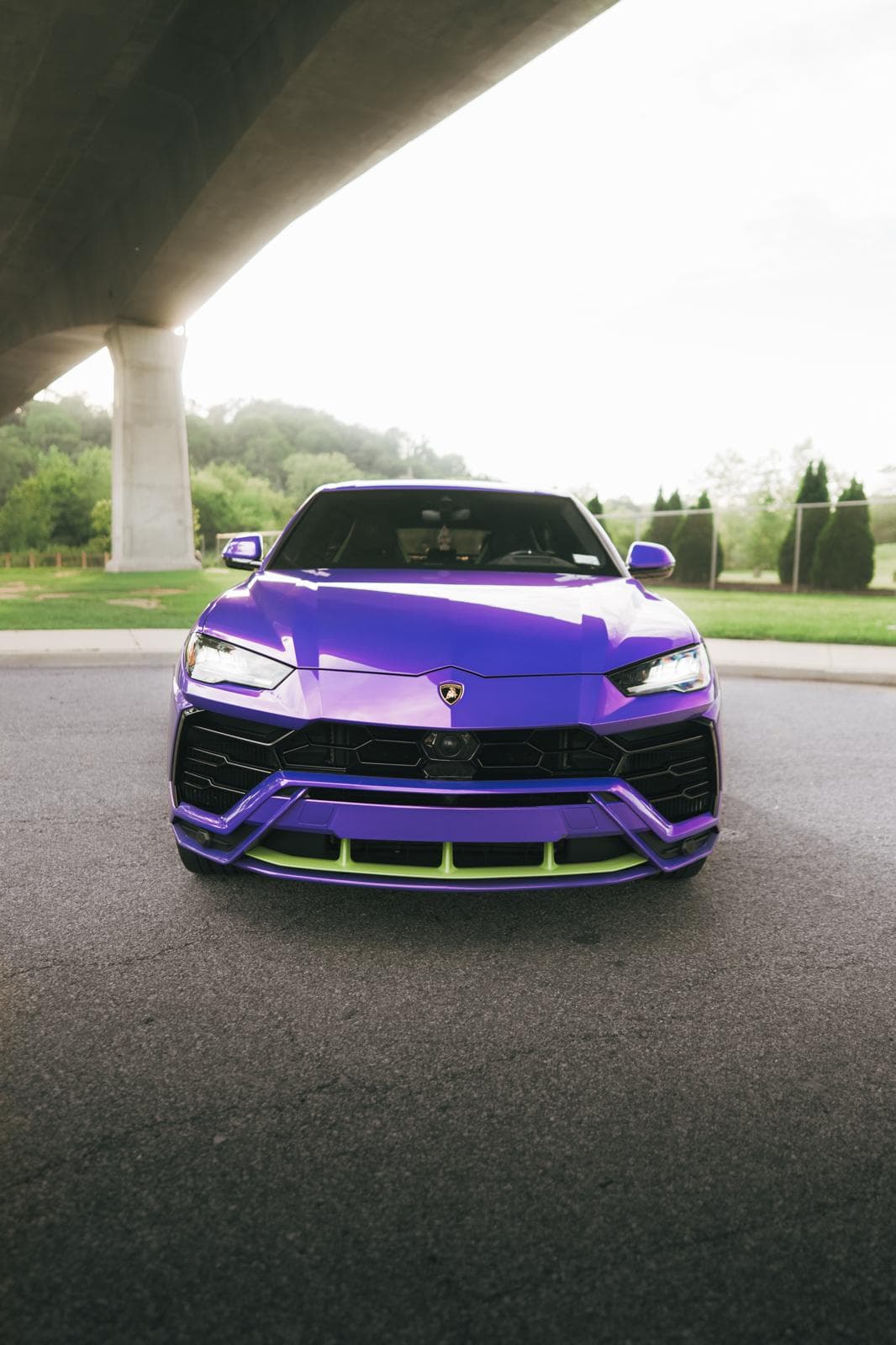 Purple Lamborghini Urus head-on, showing its lime green front splitter